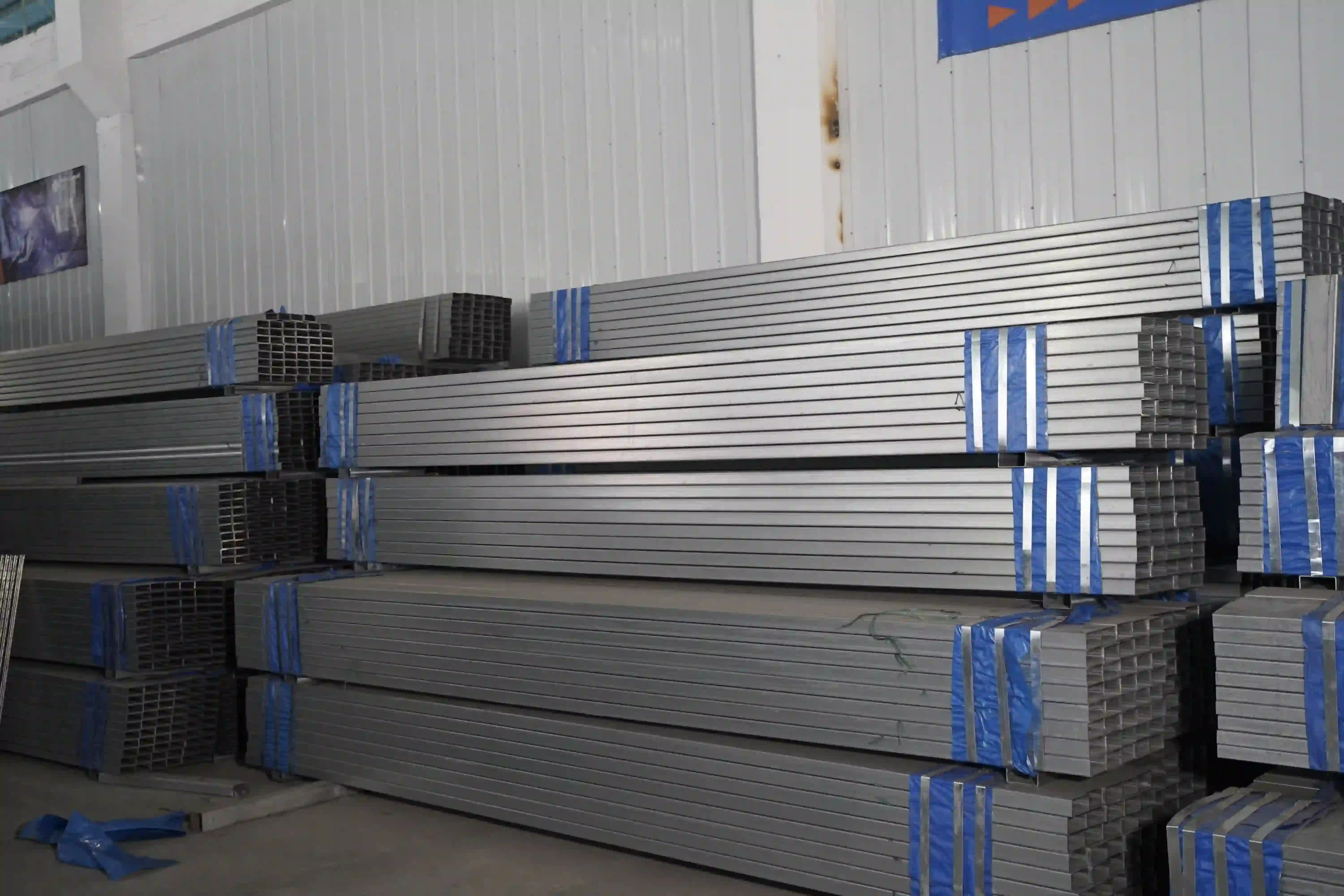 Bundled rectangular steel profiles stored for padel court fabrication