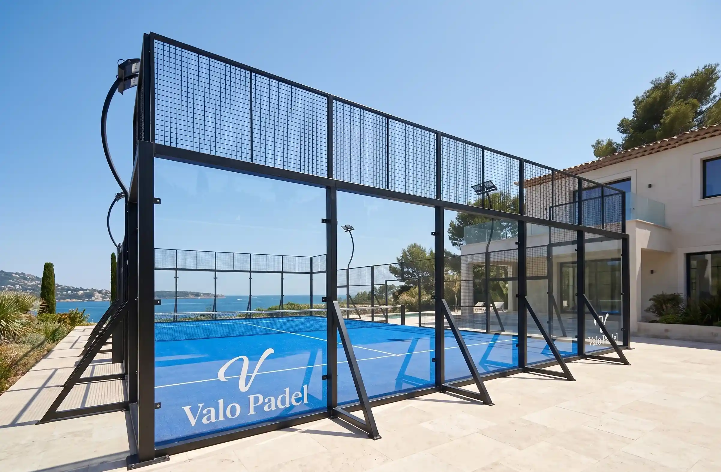 The Sovereign Freestanding padel court installed at a luxury outdoor villa, showcasing the non-invasive outrigger brackets protecting the premium floor